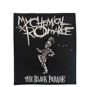 May include: A rectangular black embroidered patch featuring the white text My Chemical Romance at the top and The Black Parade at the bottom. In the center, a white skeleton figure in a marching band uniform is depicted in a walking pose.