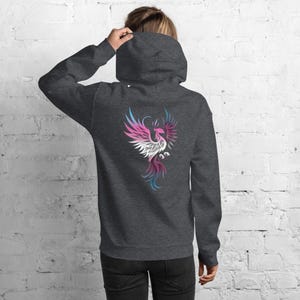 May include: Dark gray hoodie with a colorful phoenix design on the back. The phoenix is depicted in shades of pink, white, blue, and purple. The hoodie has a hood and long sleeves.