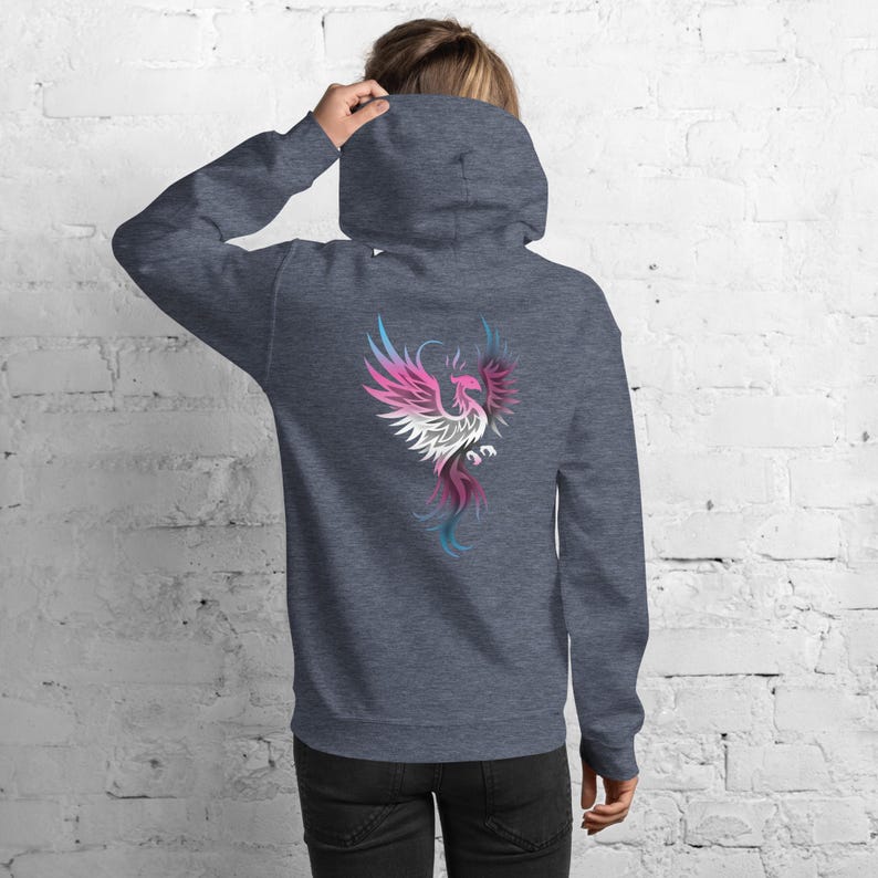 May include: A dark gray hoodie with a colorful phoenix design on the back. The phoenix is depicted in shades of pink, white, blue, and purple. The hoodie has a hood and a front pocket.
