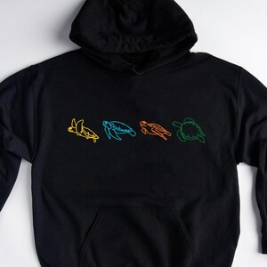 May include: Black hooded sweatshirt with a line drawing of five sea turtles in different colors on the front.