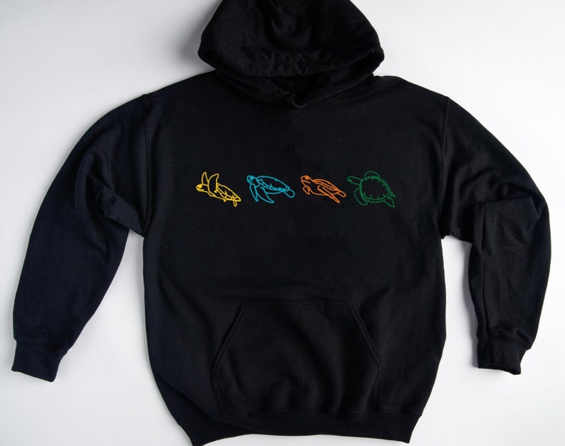 May include: Black hooded sweatshirt with a line drawing of five sea turtles in different colors on the front.