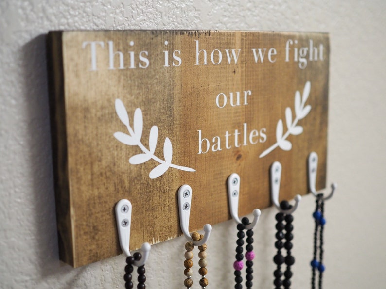 This is How We Fight Our Battles Wooden Rosary Hanger image 0