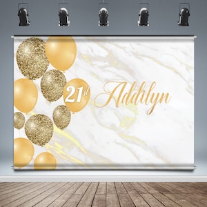 May include: White marble backdrop with gold glitter and solid gold balloons. The text "21st Addilyn" is written in gold script.