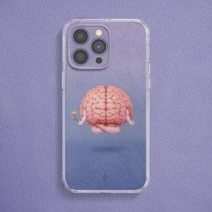 May include: A clear phone case with a light blue background and a pink brain meditating with a yellow flower. The phone case has a clear camera cutout and a white logo.