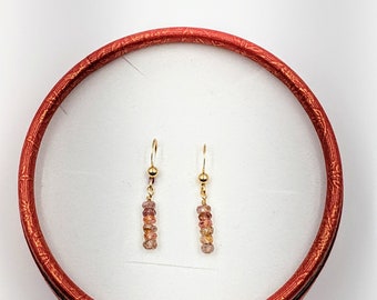 Earrings in multicolored spinels and laminated gold