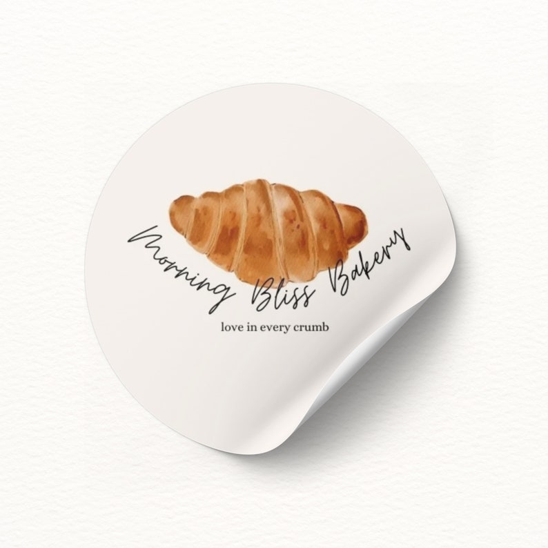 May include: A white sticker with a brown croissant illustration and the text "Morning Bliss Bakery" and "love in every crumb".