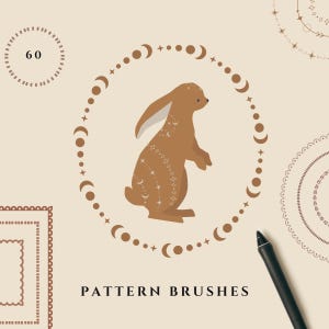 May include: A brown illustration of a rabbit with celestial designs, surrounded by a circle of moons and stars. The words "PATTERN BRUSHES" are below the rabbit. A black stylus is in the bottom right corner. The background is a light beige color.