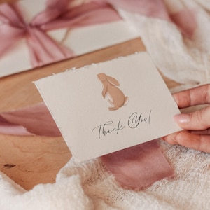 May include: A white card with a brown bunny illustration and the text "Thank You!" written in black cursive.