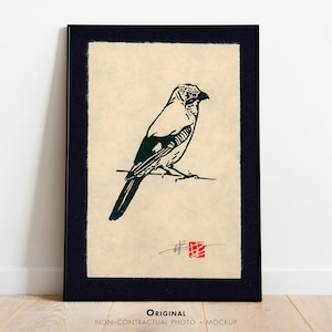 May include: Framed print of a black and white bird illustration, reminiscent of Japanese art. The bird is perched on a branch against a cream backdrop, framed in black. The artwork has a minimalist style. The print is in a black frame.