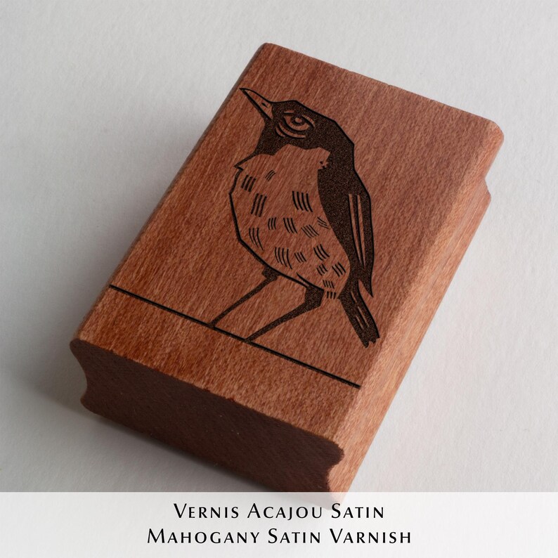 A rubber stamp with an illustration of a bird and the text EX LIBRIS CLEMENT SCARPI rests beside its stamped impression on a book page, making a parfait cadeau fait main for collectors of bijoux uniques or vintage treasures.