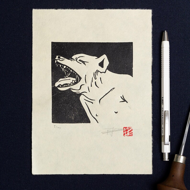 May include: Black and white woodcut print of a dog with its mouth open, howling. The print is on a cream-colored paper with a red stamp in the bottom right corner.