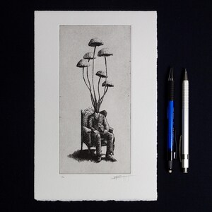 Black and white surrealist etching of a seated man in a suit with mushrooms growing from his head, creating a dreamlike botanical figure. Detailed fine art print with vintage engraving style, combining nature and human form. Contemporary surreal wall art, limited edition print signed by the artist, ideal for collectors of surrealism, mushroom art, dark academia decor, and unique modern gallery wall pieces.