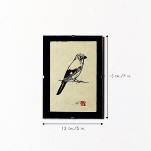 May include: Framed black and white bird art print. The artwork features a detailed illustration of a bird perched on a branch. The frame measures 18 cm high and 13 cm wide.
