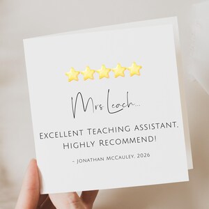 May include: A white card with the text "Mrs. Leach..." and "EXCELLENT TEACHING ASSISTANT. HIGHLY RECOMMEND!" is held in a hand. Above the text are five yellow star icons. The card is signed "- JONATHAN MCCAULEY. 2026."