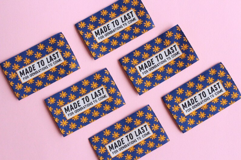 May include: Six blue fabric labels with a yellow floral pattern and the text "MADE TO LAST FOR GENERATIONS TO COME" printed in black.