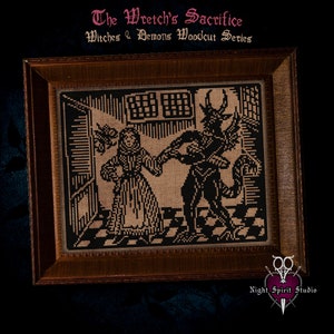 May include: A framed cross-stitch embroidery depicting a woman in a long dress being led by a horned demon. The embroidery is in black and white on a beige background. The title "The Wretch's Sacrifice" and "Witches & Demons Woodcut Series" are above the image.