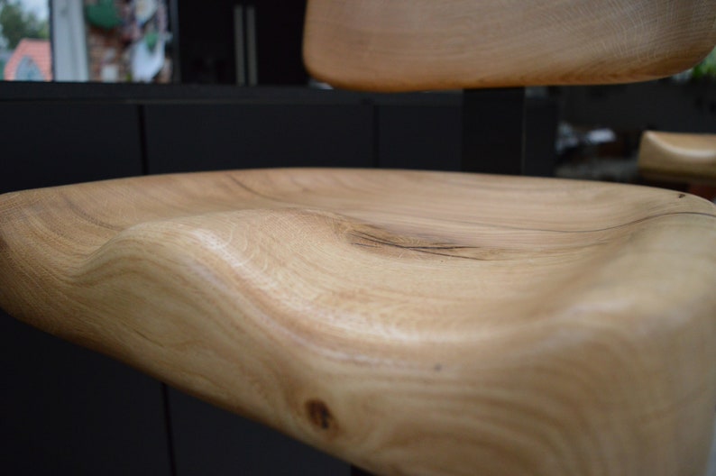Wooden bar stools tucked under kitchen counter – space-saving design