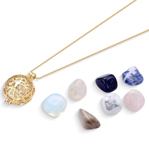 May include: A gold necklace with a cage pendant and seven assorted tumbled stones. The stones are blue, white, pink, and gray.