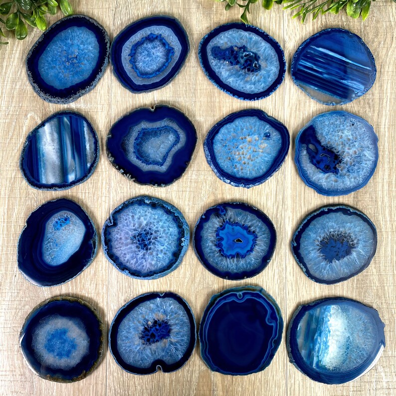 May include: Set of 16 blue agate coasters. Each coaster features a unique pattern of blue and white agate.