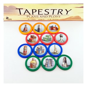 May include: A board game titled "Tapestry: Plans and Ploys" with colorful circular tokens featuring building illustrations. The tokens are arranged in a pattern, with a variety of colors including red, blue, green, and orange.
