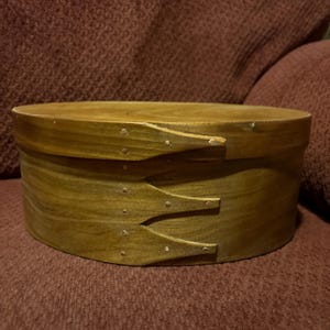 May include: A set of three ceramic mugs with a speckled, matte finish. The mugs are in shades of cream, light gray, and dark gray. Each mug has a simple, minimalist design, perfect for coffee or tea.
