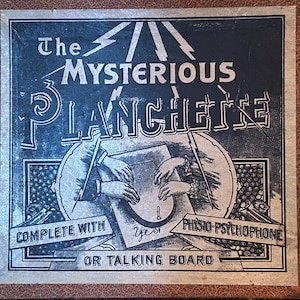 May include: Vintage "The Mysterious Planchette" talking board box. The box features a dark blue and silver graphic with the text "The Mysterious Planchette" and illustrations of hands and a planchette. The box is complete with a talking board.