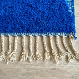 Close-up of blue Beni Ourain rug showing natural wool texture and artisan weaving