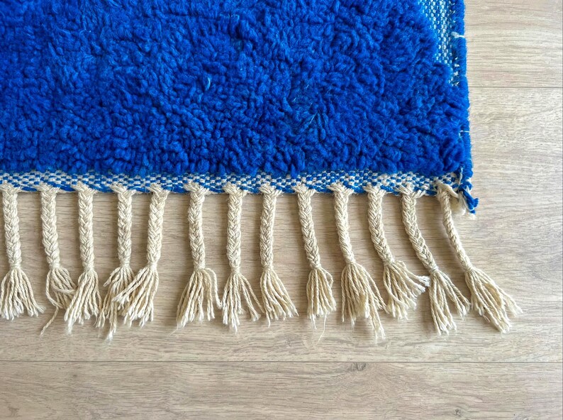 Close-up of blue Beni Ourain rug showing natural wool texture and artisan weaving