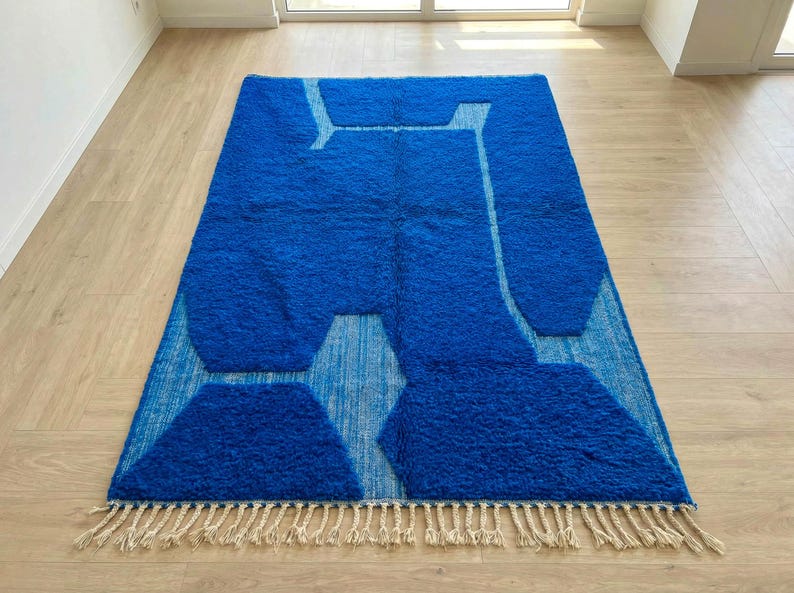 Modern living room with blue Moroccan Berber rug on wooden floor