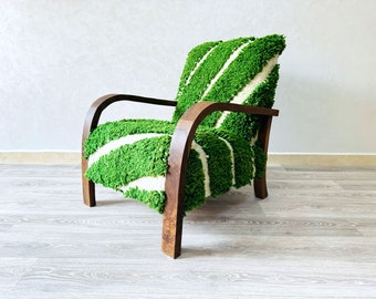 May include: A green and white striped armchair with a wooden frame. The chair has a unique, textured fabric that resembles grass.