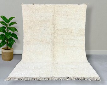 May include: A white shag rug with a subtle pattern and a fringe border.