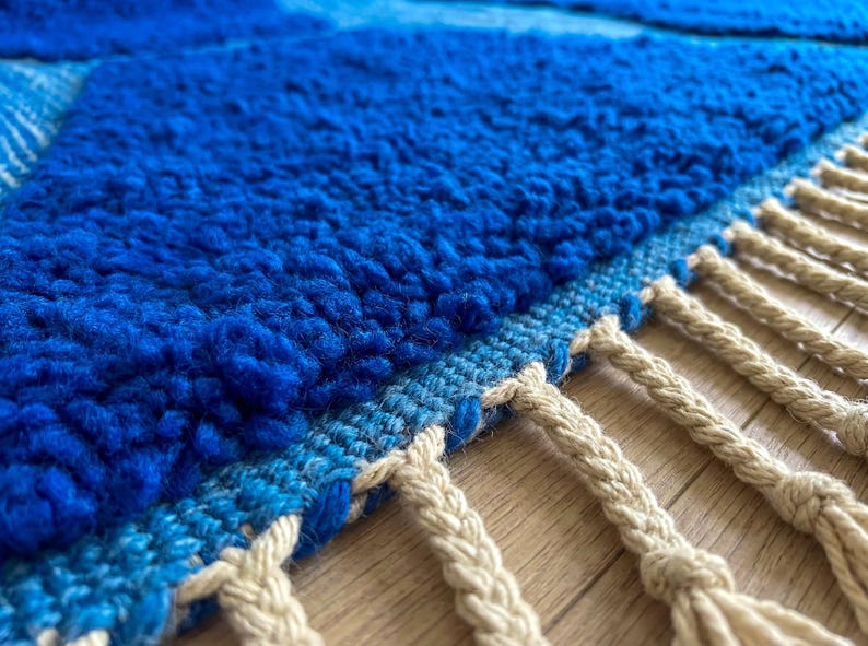Detail of handmade Moroccan rug edge with soft wool pile and fringe