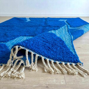 Blue Moroccan wool rug corner showing hand-knotted fringe detail