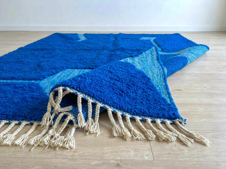 Blue Moroccan wool rug corner showing hand-knotted fringe detail