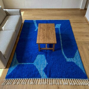 Modern living room with blue Moroccan Berber rug on wooden floor