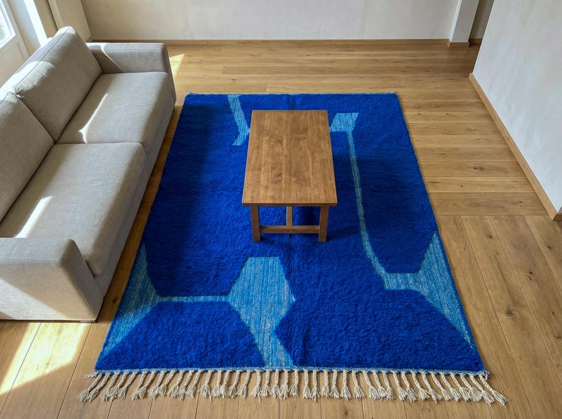 Modern living room with blue Moroccan Berber rug on wooden floor