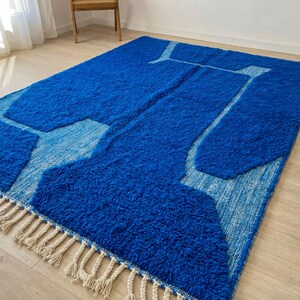 Side angle of abstract Beni Ourain rug showing thick wool pile