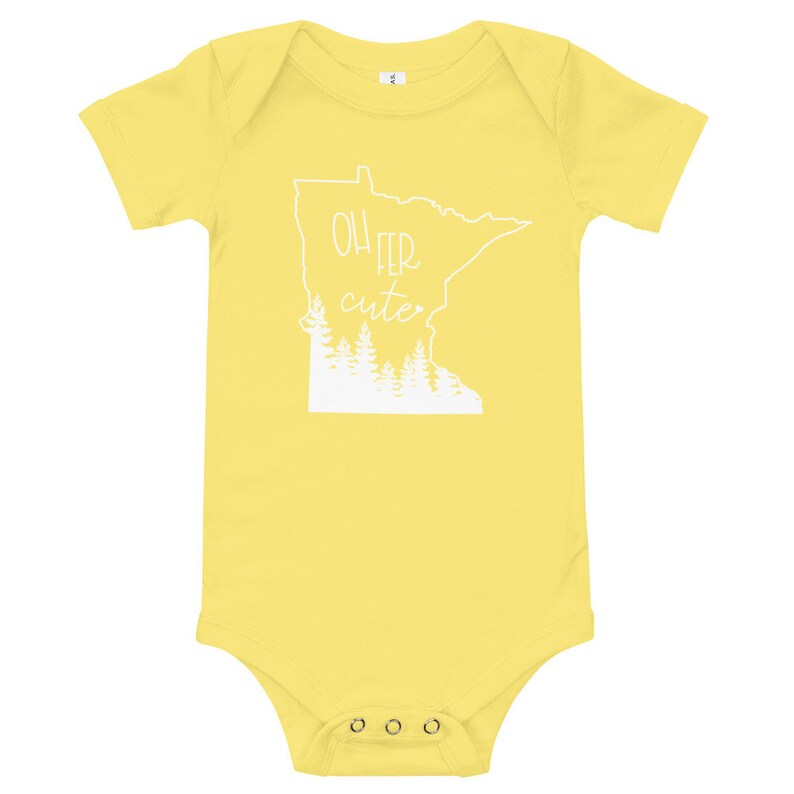 May include: A yellow baby bodysuit with short sleeves. The white graphic on the front features the outline of the state of Minnesota, the text "Oh Fer Cute", and a row of trees.