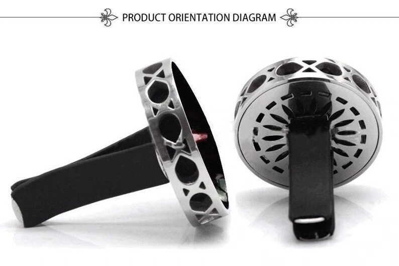 May include: Silver car air freshener with a geometric design. The air freshener has a black clip to attach to a car vent.