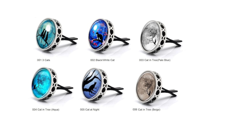 May include: Six different car air fresheners with various cat designs. Each air freshener is silver with a round glass insert featuring a different cat image. The images include three cats, a black and white cat, a cat in a tree, a cat in a tree with an aqua background, a cat at night, and a cat in a tree with a beige background.