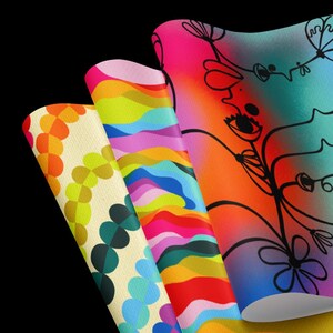 May include: Three colourful wrapping paper designs. The first design features a pattern of overlapping circles in shades of yellow, orange, green, and blue. The second design features a pattern of wavy lines in shades of pink, blue, green, yellow, and red. The third design features a black and white illustration of a stylised flower with a gradient background in shades of blue, purple, pink, and orange.