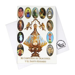 May include: A white booklet with a colorful image of the Virgin Mary on the front cover. The image is surrounded by smaller images of saints and angels. The title of the booklet is "Mi Compendio de Oraciones y El Santo Rosario".