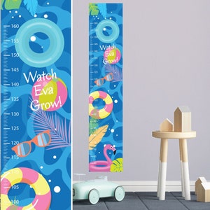May include: A blue and white growth chart with a summer theme. The chart features a flamingo float, sunglasses, and colourful inner tubes. The text "Watch Eva Grow!" is printed on the chart.