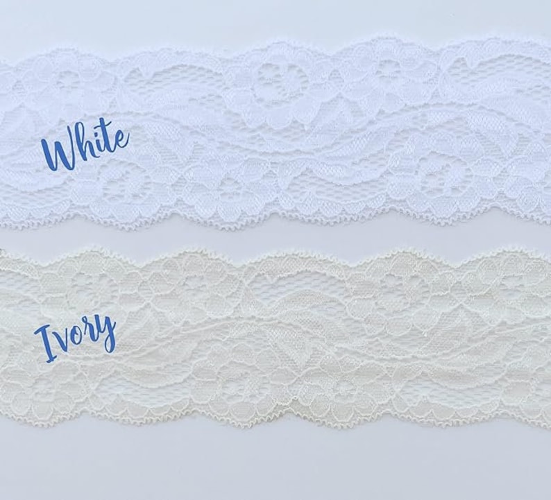 May include: Two samples of lace trim, one white and one ivory. The lace is delicate and has a floral pattern.