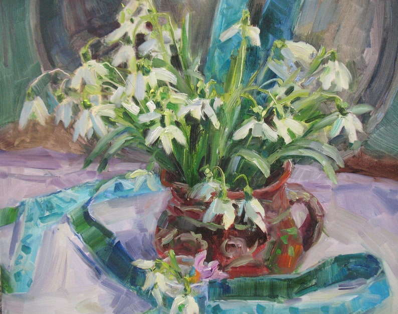 May include: An oil painting of a bouquet of white snowdrop flowers in a brown ceramic pitcher. The flowers have green stems and leaves. A turquoise ribbon and white cloth are in the background.