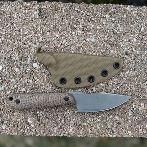 May include: A small, dark grey knife with a brown, textured handle and a black sheath with snap closures.