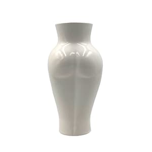 May include: A white ceramic vase with a unique, rounded shape. The vase has a smooth, glossy finish and a classic, elegant design.