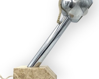 May include: A chrome desk lamp with a spherical shade and a travertine base. The lamp has a flexible arm and a cord.