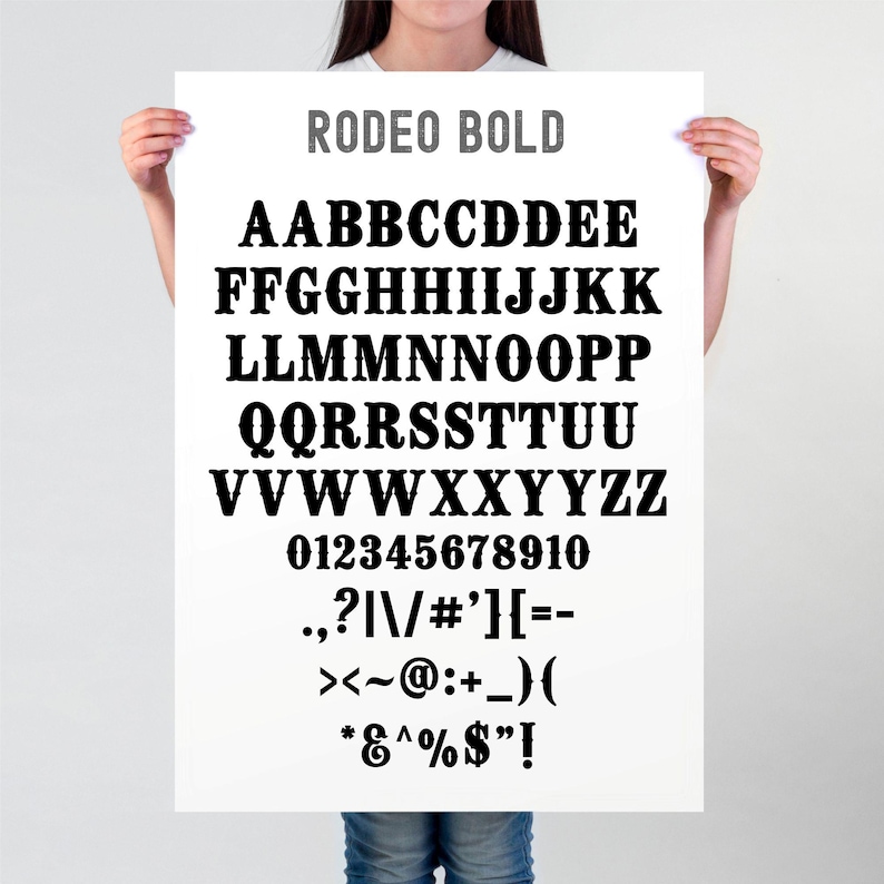May include: A white poster with the text "RODEO BOLD" in gray at the top. The poster features a black font with uppercase letters, numbers, and punctuation marks.