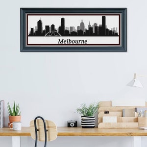May include: Framed black and white Melbourne skyline art print. The cityscape silhouette includes iconic buildings and a bridge, set against a white background. The word "Melbourne" is printed below the skyline.